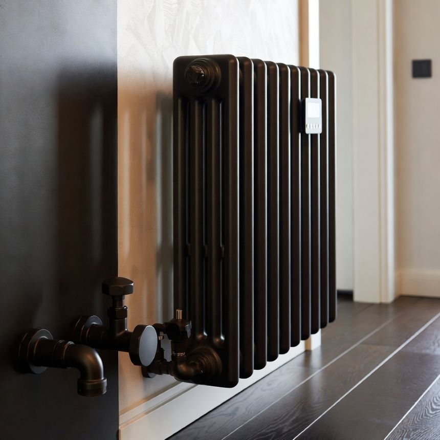 designer radiator and matte black plumbing fixtures